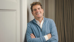 Andrew Mclaughlan leaning against a door